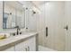 Well-lit bathroom featuring a marble countertop, modern fixtures, and frameless glass walk-in shower at 4522 S Hale Ave, Tampa, FL 33611