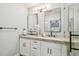 Bathroom features double sinks, marble countertop, framed mirrors, and glass shower at 4522 S Hale Ave, Tampa, FL 33611