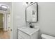Stylish bathroom with a marble countertop vanity and a modern mirror, showcasing a clean, minimalist design at 4522 S Hale Ave, Tampa, FL 33611