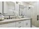 Bathroom features double sinks, marble countertop, framed mirrors, and glass shower at 4522 S Hale Ave, Tampa, FL 33611