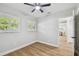 Bright bedroom with wood floors, ceiling fan, and plantation shutters; view into dining area at 4522 S Hale Ave, Tampa, FL 33611