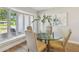 Bright dining room features a bay window and a glass table, offering an inviting space for entertaining at 4522 S Hale Ave, Tampa, FL 33611