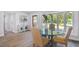 Bright dining room featuring wood floors, and a glass table next to a large window at 4522 S Hale Ave, Tampa, FL 33611