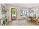 Elegant dining area with wood floors, bay window, glass table, and stylish decor with a decorative front door at 4522 S Hale Ave, Tampa, FL 33611
