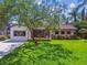Charming single-story home with a lush front yard, mature tree, and well-maintained landscaping at 4522 S Hale Ave, Tampa, FL 33611
