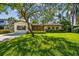 Charming home featuring a beautiful lawn, mature trees, and meticulously maintained landscaping at 4522 S Hale Ave, Tampa, FL 33611