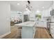 Open concept living room and kitchen boasts stainless steel appliances, a center island, and modern lighting at 4522 S Hale Ave, Tampa, FL 33611