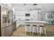 Bright, renovated kitchen featuring stainless steel appliances, white cabinets and a marble countertop island at 4522 S Hale Ave, Tampa, FL 33611