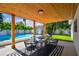 Outdoor dining on lanai with beautiful wood ceiling, adjacent to pool and backyard at 4522 S Hale Ave, Tampa, FL 33611