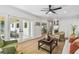 Bright living room with wood floors, ceiling fan, and french doors to outdoor covered patio at 4522 S Hale Ave, Tampa, FL 33611
