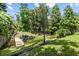 Spacious backyard featuring a small pond, wooden dock, and mature trees perfect for relaxation and enjoying nature at 6051 65Th N Ave, Pinellas Park, FL 33781