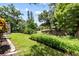 Lush backyard with a pond, mature trees, and a well-maintained lawn at 6051 65Th N Ave, Pinellas Park, FL 33781