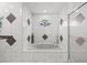 Bright bathroom featuring a bathtub, shower and decorative mosaic tile details at 6051 65Th N Ave, Pinellas Park, FL 33781