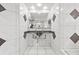 Bright bathroom with double sinks and mosaic tile details on the walls at 6051 65Th N Ave, Pinellas Park, FL 33781