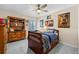 Cozy bedroom with ceiling fan, dark blue bedding and unique furniture at 6051 65Th N Ave, Pinellas Park, FL 33781