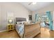 Bedroom featuring an upholstered headboard bed, blue accents, and a sliding glass door leading to pool at 6051 65Th N Ave, Pinellas Park, FL 33781