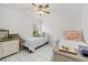 Bedroom with twin beds, ceiling fan and white tile floor at 6051 65Th N Ave, Pinellas Park, FL 33781