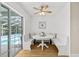 Bright breakfast nook with white built-in benches, table, and sliding glass doors to the pool at 6051 65Th N Ave, Pinellas Park, FL 33781