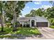 Charming single-story home with a well-manicured lawn, mature trees, and a two-car garage at 6051 65Th N Ave, Pinellas Park, FL 33781
