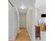 Hallway featuring wood floors and white walls with closet and office space visible at 6051 65Th N Ave, Pinellas Park, FL 33781