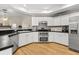 Modern kitchen featuring white cabinets, stainless steel appliances, and stylish backsplash, offering a clean and functional space at 6051 65Th N Ave, Pinellas Park, FL 33781