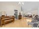 Spacious living room featuring hardwood floors, ample seating, piano, and open layout perfect for entertaining and Gathering gatherings at 6051 65Th N Ave, Pinellas Park, FL 33781
