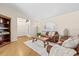Cozy living room showcasing hardwood floors, arched window, comfortable seating, and decorative shelving for a warm ambiance at 6051 65Th N Ave, Pinellas Park, FL 33781