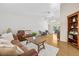Comfortable living room featuring hardwood floors, vaulted ceiling, and stylish furniture with a view of the backyard at 6051 65Th N Ave, Pinellas Park, FL 33781