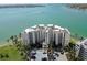 Aerial view of waterfront condo building featuring water views and palm tree landscaping at 6105 Bahia Del Mar Cir # 682, St Petersburg, FL 33715