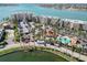 Aerial view of condo buildings with pool, clubhouse, lush landscaping and water view at 6105 Bahia Del Mar Cir # 682, St Petersburg, FL 33715
