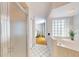 Bathroom with a glass shower, tub, and view of the bedroom at 6105 Bahia Del Mar Cir # 682, St Petersburg, FL 33715