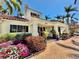 Beautiful building entrance adorned with colorful flowers and lush greenery at 6105 Bahia Del Mar Cir # 682, St Petersburg, FL 33715