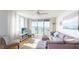 Bright living room with modern furnishings, balcony access, and water views at 6105 Bahia Del Mar Cir # 682, St Petersburg, FL 33715