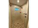 Stylish bathroom featuring tile walls, multiple shower heads and a patterned tile shower floor at 6153 La Pine Rd, Brooksville, FL 34602