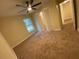 Cozy bedroom with plush carpeting, a ceiling fan, and a window offering natural light at 6153 La Pine Rd, Brooksville, FL 34602