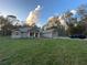 Well-maintained single-Gathering home with a spacious front yard, driveway, and a neatly manicured lawn at 6153 La Pine Rd, Brooksville, FL 34602