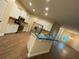 Open concept kitchen with stainless steel appliances, a breakfast bar, and tile floors throughout at 6153 La Pine Rd, Brooksville, FL 34602