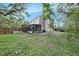 View of the backyard, featuring a screened-in porch and wooden fence at 6263 Oak Cluster Cir, Tampa, FL 33634