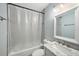 Well-lit bathroom with a shower and tub combination, a shower curtain and modern fixtures at 6263 Oak Cluster Cir, Tampa, FL 33634