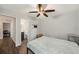 Comfortable bedroom with wood-look floors, ceiling fan, and ensuite bathroom access at 6263 Oak Cluster Cir, Tampa, FL 33634
