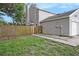 Side view of a house with gray siding and a wooden fence and a touch of landscaping at 6263 Oak Cluster Cir, Tampa, FL 33634