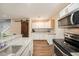 Bright kitchen with stainless steel appliances, white cabinets, and granite countertops and a sliding barn door at 6263 Oak Cluster Cir, Tampa, FL 33634