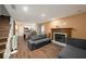 Spacious living room with fireplace, wood floors and open access to the kitchen at 6263 Oak Cluster Cir, Tampa, FL 33634