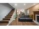 Open living room with stairs, modern flooring, and an open doorway to kitchen at 6263 Oak Cluster Cir, Tampa, FL 33634