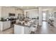 Spacious kitchen with granite countertops, stainless steel appliances, and a functional center island with seating at 6413 Gladeview Way, Land O Lakes, FL 34638