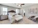 Serene main bedroom featuring a luxurious bed, elegant decor, and access to an en-suite bathroom at 6413 Gladeview Way, Land O Lakes, FL 34638
