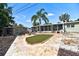 A delightful backyard features a decorative grass pad and a spacious screened-in porch with elegant tile flooring at 6912 14Th N St # 6912, St Petersburg, FL 33702