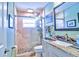 Modern bathroom showcasing a glass-enclosed shower, granite countertop, and stylish fixtures at 6912 14Th N St # 6912, St Petersburg, FL 33702