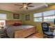 Bedroom features natural light, a wooden bed frame, and an inviting work space at 6912 14Th N St # 6912, St Petersburg, FL 33702