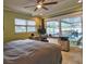 Bedroom featuring a ceiling fan, a window with blinds, and sliding glass door to the pool at 6912 14Th N St # 6912, St Petersburg, FL 33702